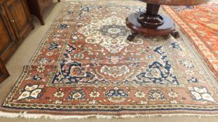 A late 20th Century Caucasian Carpet, central panel of floral lozenges, mainly puce field with