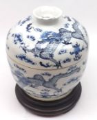 A Chinese Covered Jar of circular baluster form, painted in underglaze blue with dragons and smoke