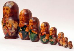 A Graduated Wooden Set of Ten Russian Dolls, from 10” to ¾” in size, decorated with pictures of