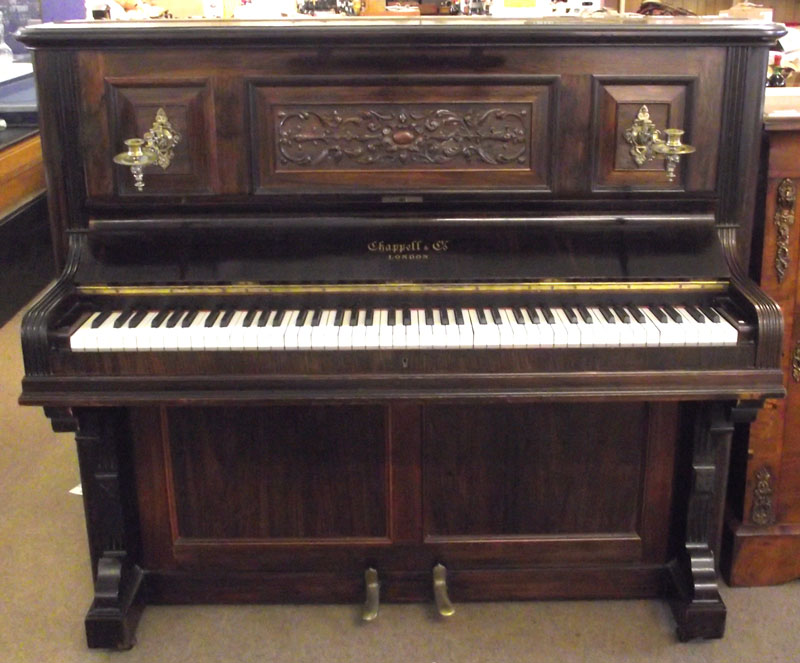 A Chappell & Co Rosewood Cased Overstrung Upright Piano, the front applied with swivelling brass