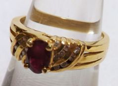 A high grade precious metal Ring set with a centre Dark Red Ruby, flanked to each side by eight