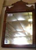 A small Walnut Framed Chippendale style Mirror with fretwork carved pediment, 9 ¾” wide