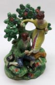 A Staffordshire Bocage Back Figure Group of a shoemaker attending to a young lady’s feet,