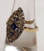 A hallmarked 9ct Gold Navette shaped Ring set with three Mid-Blue Sapphires surrounded by small