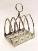 A George V Toast Rack of five lancet-shaped bars to a rectangular base with central strengthening
