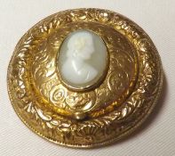 A Victorian Engraved Gold Fronted Brooch, the centre panel with raised Cameo portrait opening a