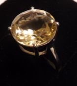 A white metal Dress Ring set with a large cut circular Citrine of pale colour, 13mm diameter,