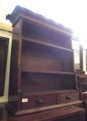 A small 19th Century Oak Waterfall Bookcase, fitted with three shelves and two bottom drawers with