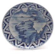 A Chinese Circular Plate, the centre decorated in underglaze blue with Chinese river scene within