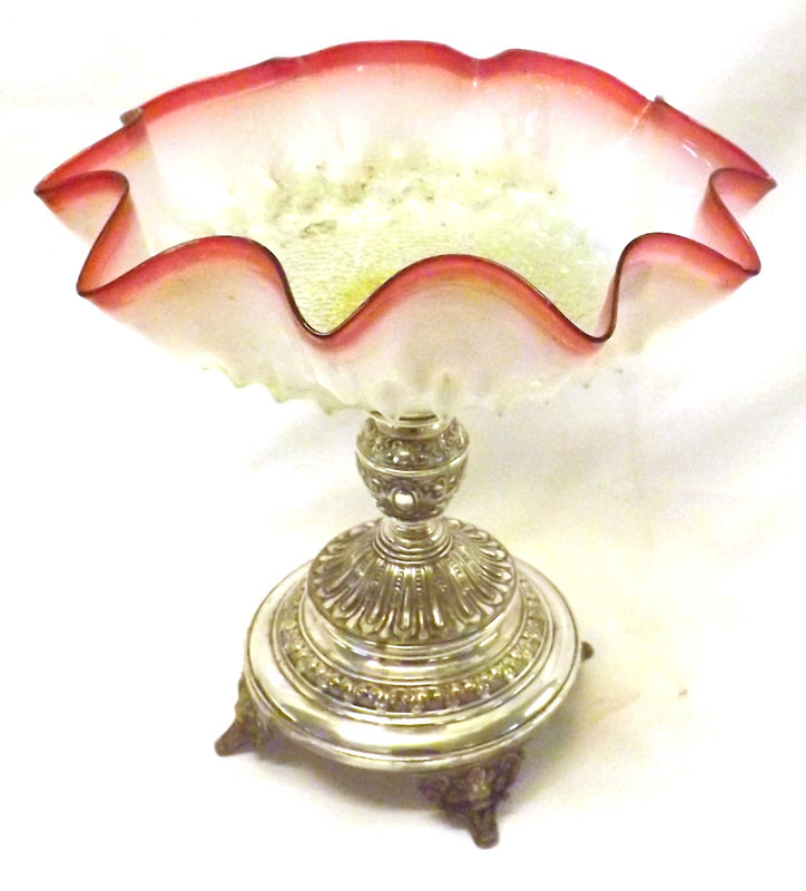 An unusual Tazza or Table Decoration, the Vaseline and Cranberry Glass frilled bowl to a silver