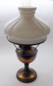 An early 20th Century Oil Lamp with white opaque glass shade, clear glass chimney to a copper body