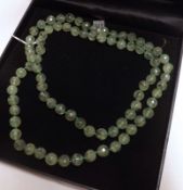 A facetted Prehnite Bead Necklace, 84cm long, approximately 4mm diameter beads