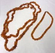 A Long Row of Natural Amber Fragments, approximately 140cm long; together with a Baltic Amber Bead