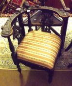 A European Gothic style Ebonised Oak Corner Chair the curved top rail moulded in the centre with a