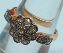 An early 20th Century 18ct Gold and Platinum all Diamond Set Cluster Ring of flower head design with