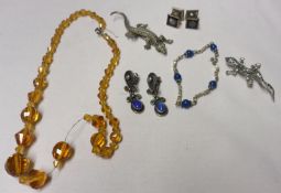 A Mixed Lot comprising: an orange Glass Bead Necklace; a white metal and Marcasite Lizard Brooch x
