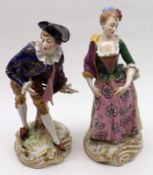 A pair of late 19th/early 20th Century Continental Figures of a young dandy and friend, decorated