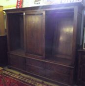 A large Eric Bates Bespoke Oak Wardrobe, fitted with three panelled doors above six drawers with