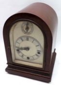 An early 20th Century German triple barrel Mantel Clock, the arched case with moulded base on