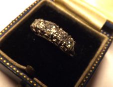 An unmarked precious metal five graduated Brilliant Cut Diamond Ring of approximately 1.2 ct total