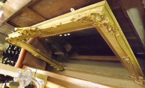 A large 19th Century Overmantel Mirror, in gilded foliage carved frame, bears retailer’s label to