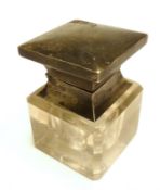 A George V Inkwell of square form with hinged lid and clear glass body, 3” high
