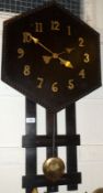 An early 20th Century Continental stained Oak Wall Clock, the hexagonal surround with beaded rim, to