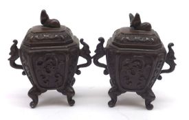 A pair of Oriental Bronze Small Containers, of canted rectangular form, the lift-off covers with