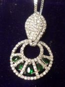 An Art Deco style white metal pierced openwork Pendant set with Green Topaz and White Sapphires,