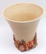 A Clarice Cliff Trumpet Vase, with plain pale puce body and coloured relief moulded floral foot,