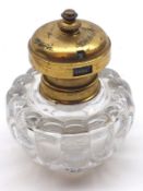 An unusual early 20th Century Clear Glass Inkwell, the hinged metal lid fitted with an integral