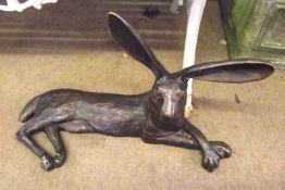 A modern Patinated Bronze Model of a recumbent hare, 23” wide