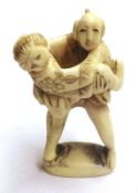 A small Carved Ivory Figure Group of a Japanese erotic couple, 2” high