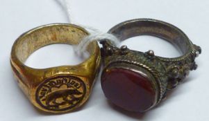 Two Antique base metal Rings, one with seal front depicting an animal and wording, the other with