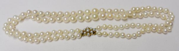 A double strand of Graduated Cultured Pearls with hallmarked 9ct Gold Pearl-set Clasp, 84cm long,