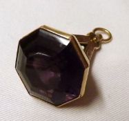 Of Masonic Interest – an Edwardian 9ct Gold Fob with purple stone inset and featuring a group of