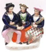 A 19th Century Staffordshire Figure Group, “Auld Lang Syne”, modelled as three seated figures,