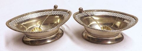 A pair of George V Oval Salts, pierced rims, raised on oval spreading feet; together with a pair