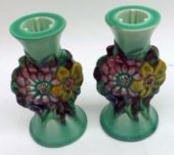 A pair of Clarice Cliff “My Garden” Candlesticks with green glaze streaked bodies and central panels