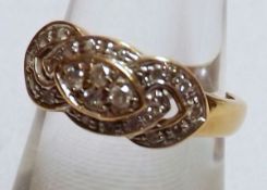 A hallmarked 18ct Gold Ring, set with four interlocking panels of small Brilliant Cut Diamonds