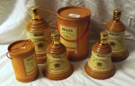 Six Graduated Bells Decanters including one in canister