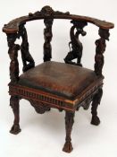 A European Gothic style Oak Corner Chair, the curved top rail elaborately carved with putti head and