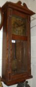 A mid 20th Century Oak Wall Clock, the overhanging cornice surmounted by a shaped pediment, to a