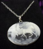 An Italian white metal framed oval Pendant in white and black Onyx depicting Cameo scene of figures,