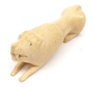 A Primitive type Carved Ivory Model of a lion with black spotted eyes, 5” long