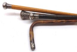 A collection of three Malacca and Hardwood Walking Sticks, each with hallmarked Silver button