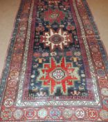 A 20th Century Caucasian Wool Carpet, triple gull border, central panel of three geometric lozenges,