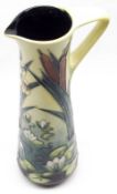 A Moorcroft Ewer, decorated with a Lily Pad/Bulrush design, Limia pattern, in colours on a green and
