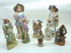 A group of seven late 19th/early 20th Century Bisque Models of Children, decorated in various