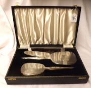 A Cased Three Piece Silver Backed Dressing Table Set, with banded engine-turned decoration,